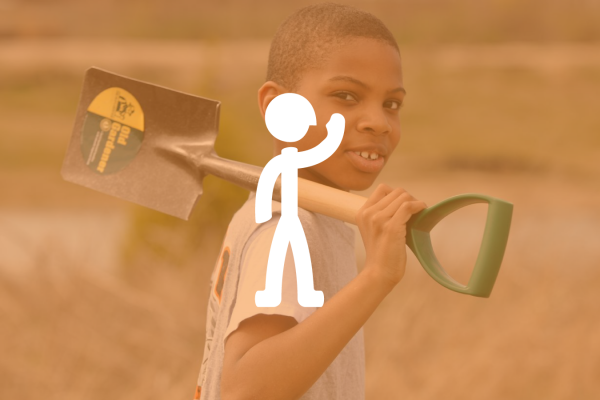 a young boy holding a shovel